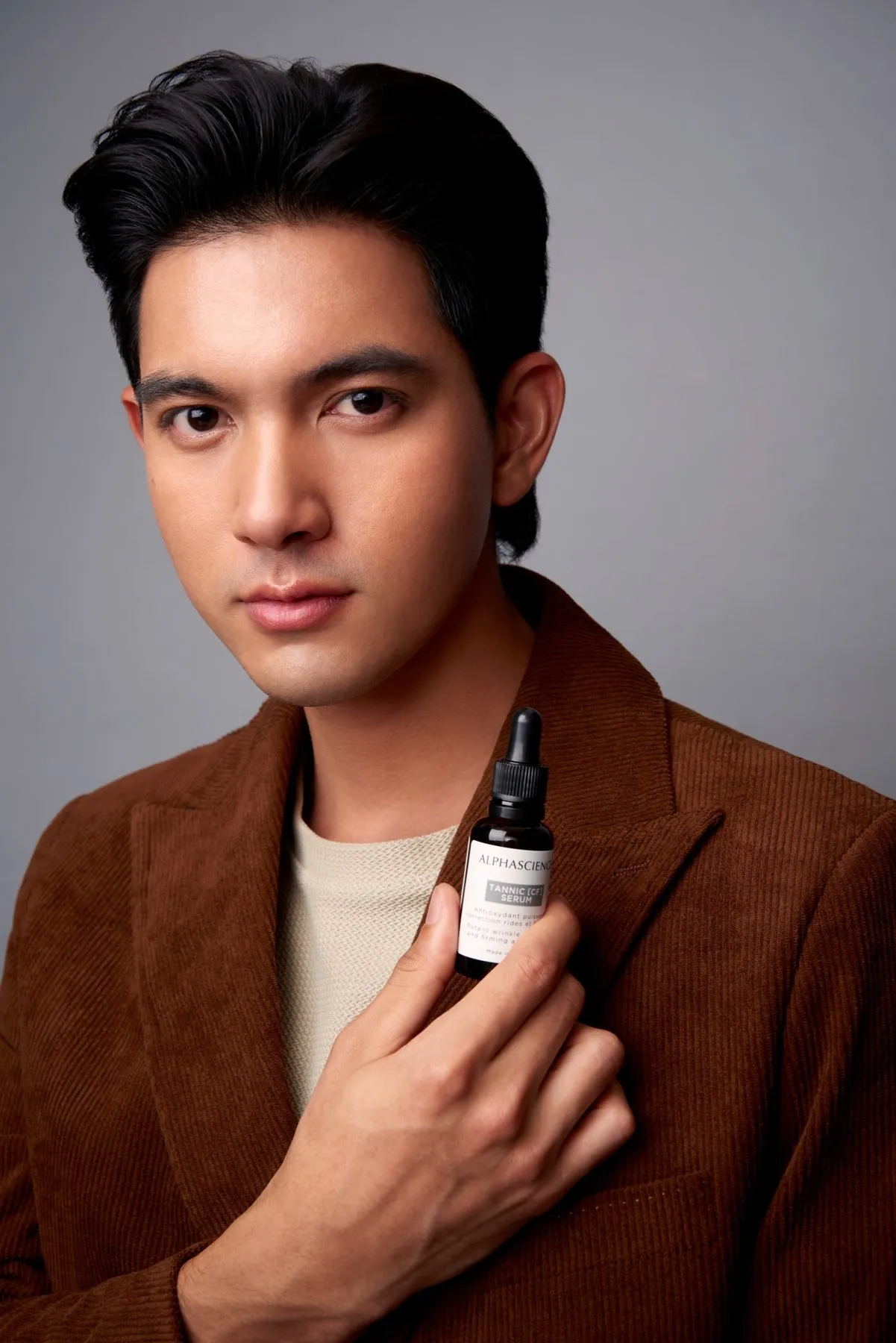 Serum product shot held by a model