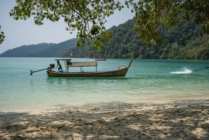 Film location scouted by Bangkok Production Company in Thailand: beach with a longtail boat