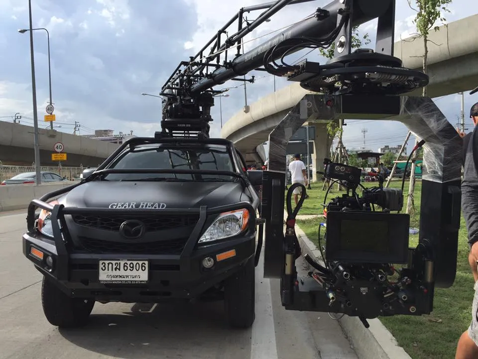 Camera car with a crane arm and remote head on a road shoot