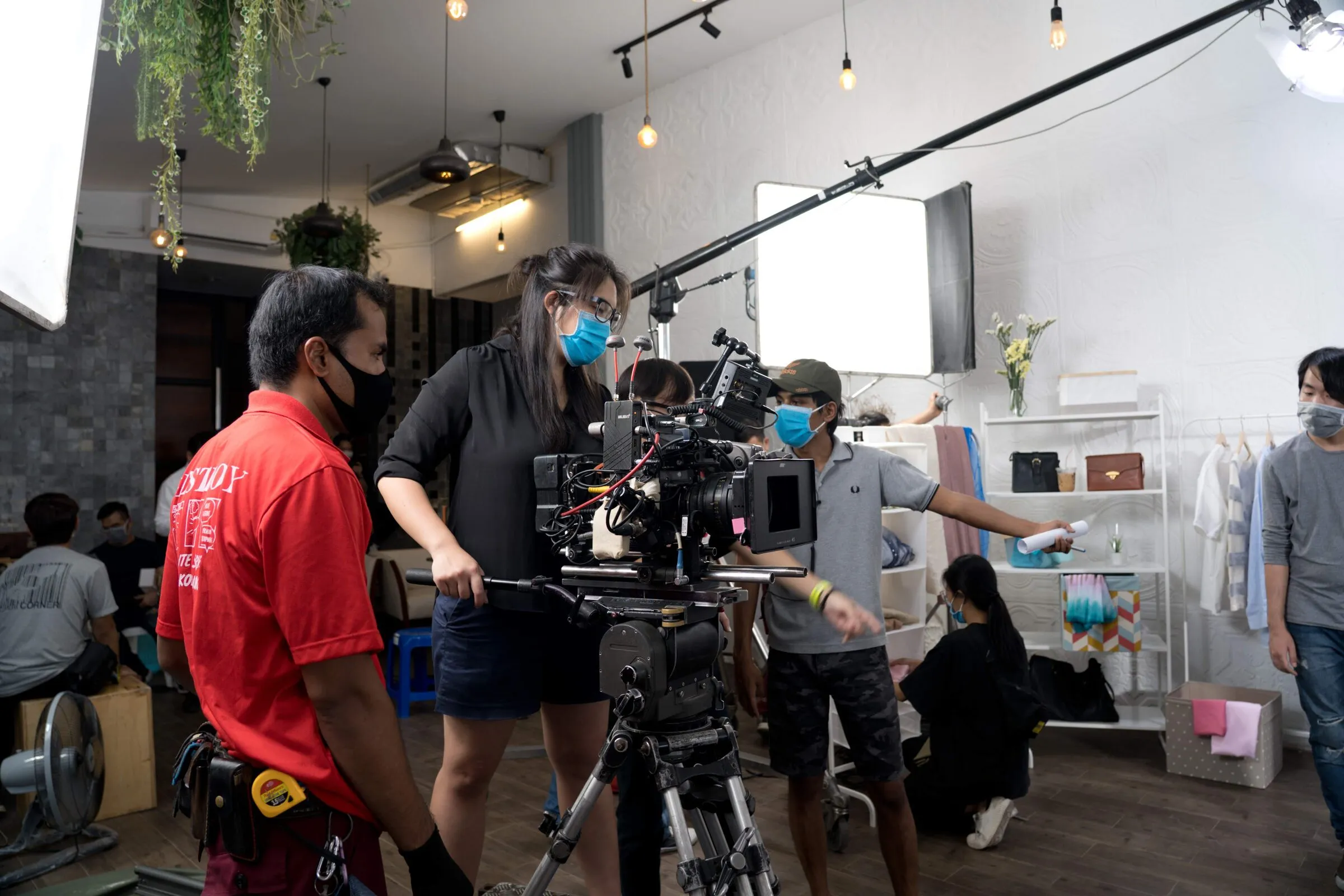 Camera team with a cinema camera on a boutique set for a Visa commercial