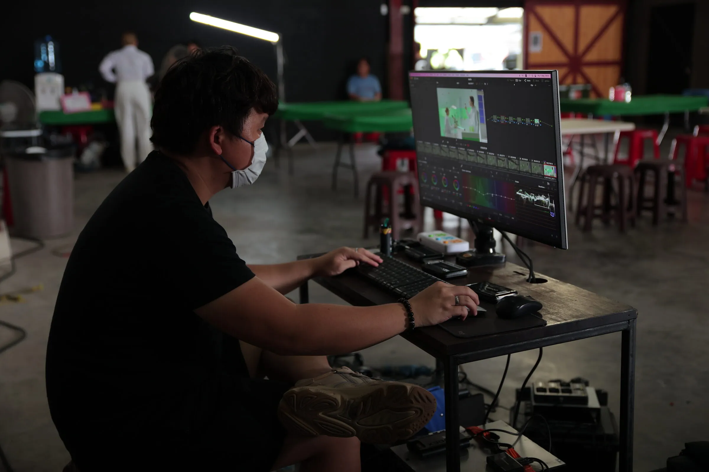 DIT checking footage and scopes at his station on set