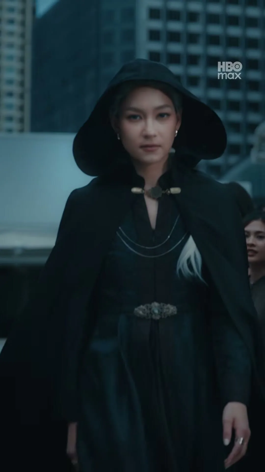 The hooded stranger walking through a Bangkok crowd