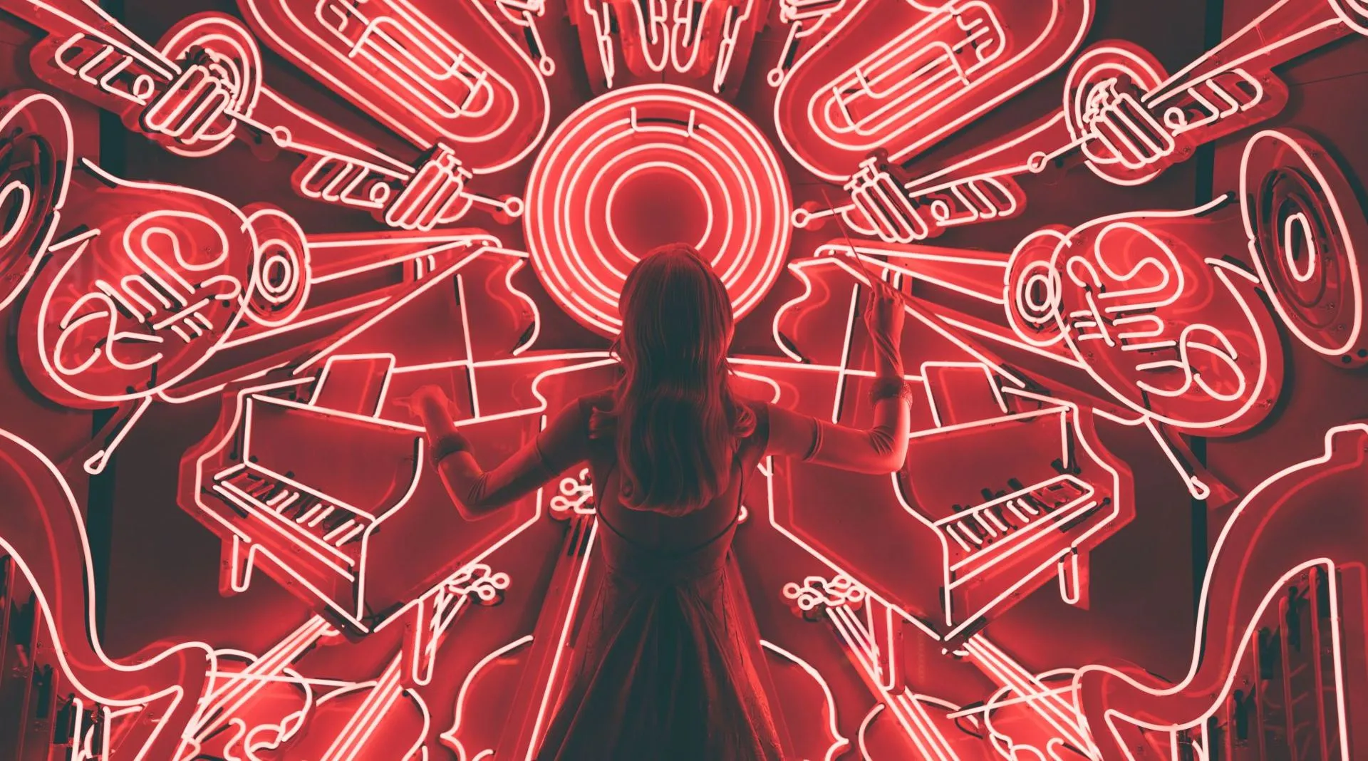 Neon artwork of a musician surrounded by instruments