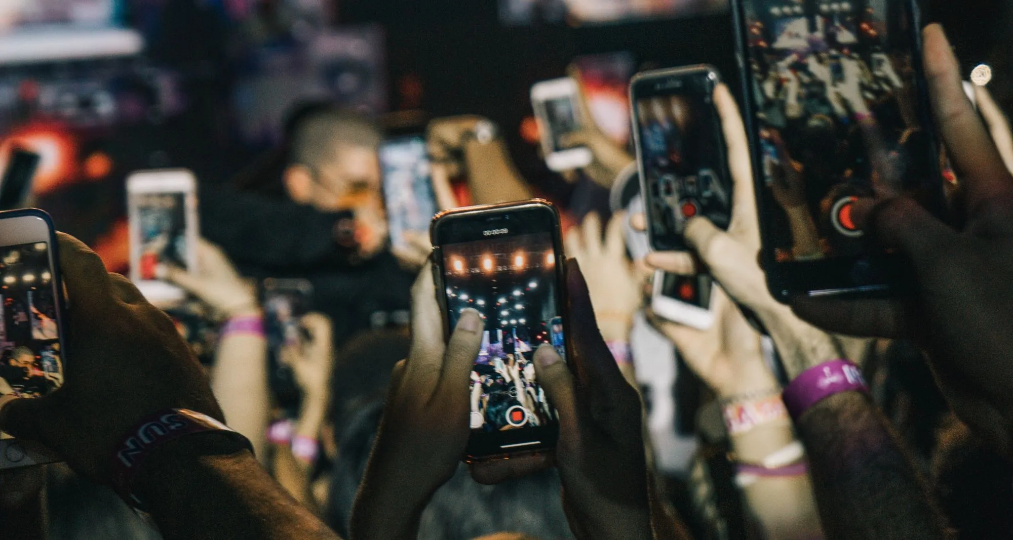 Concert crowd filming the stage with their phones