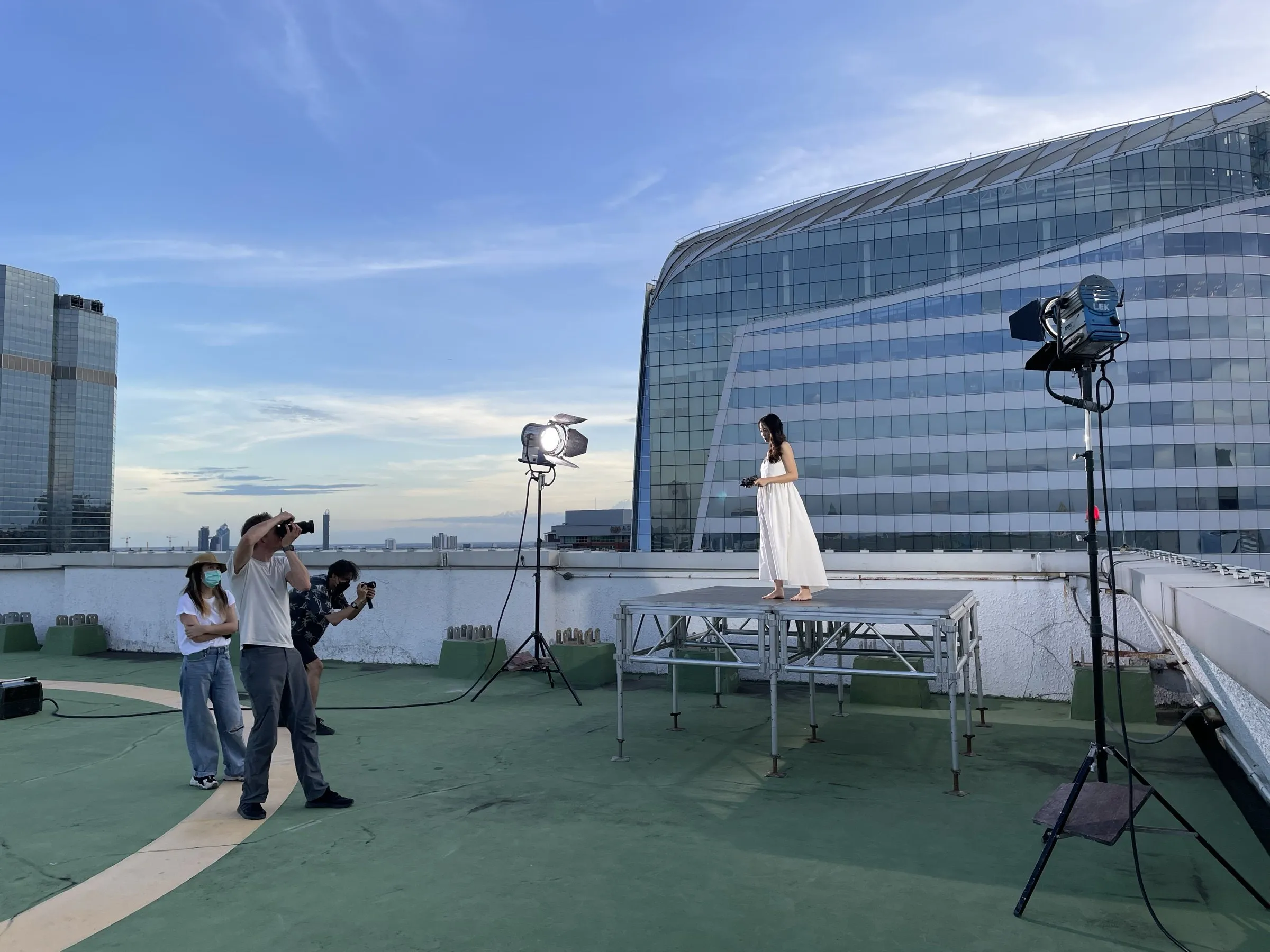 Lighting crew setting up HMI lights for a rooftop shoot in Bangkok