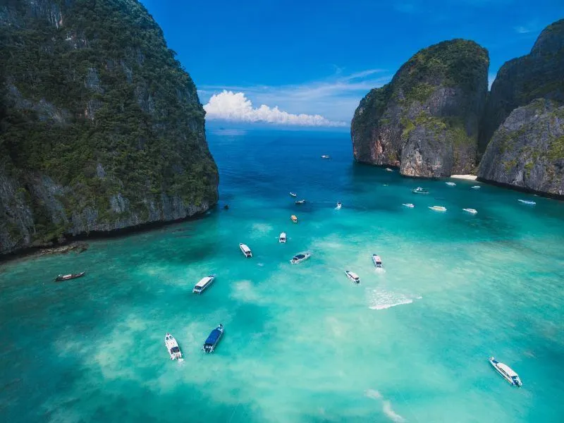 Film location scouted by Bangkok Production Company in Thailand: limestone bay with boats, seen from the air