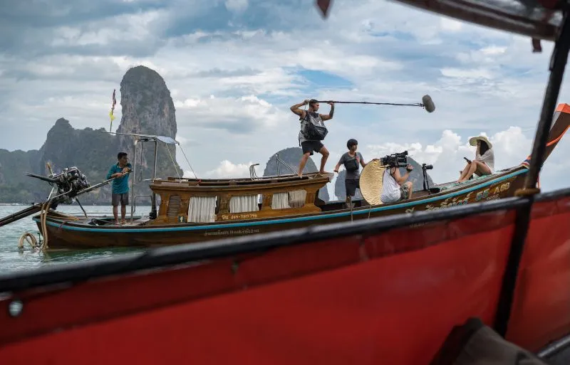 Film crew shooting from a longtail boat in Thailand