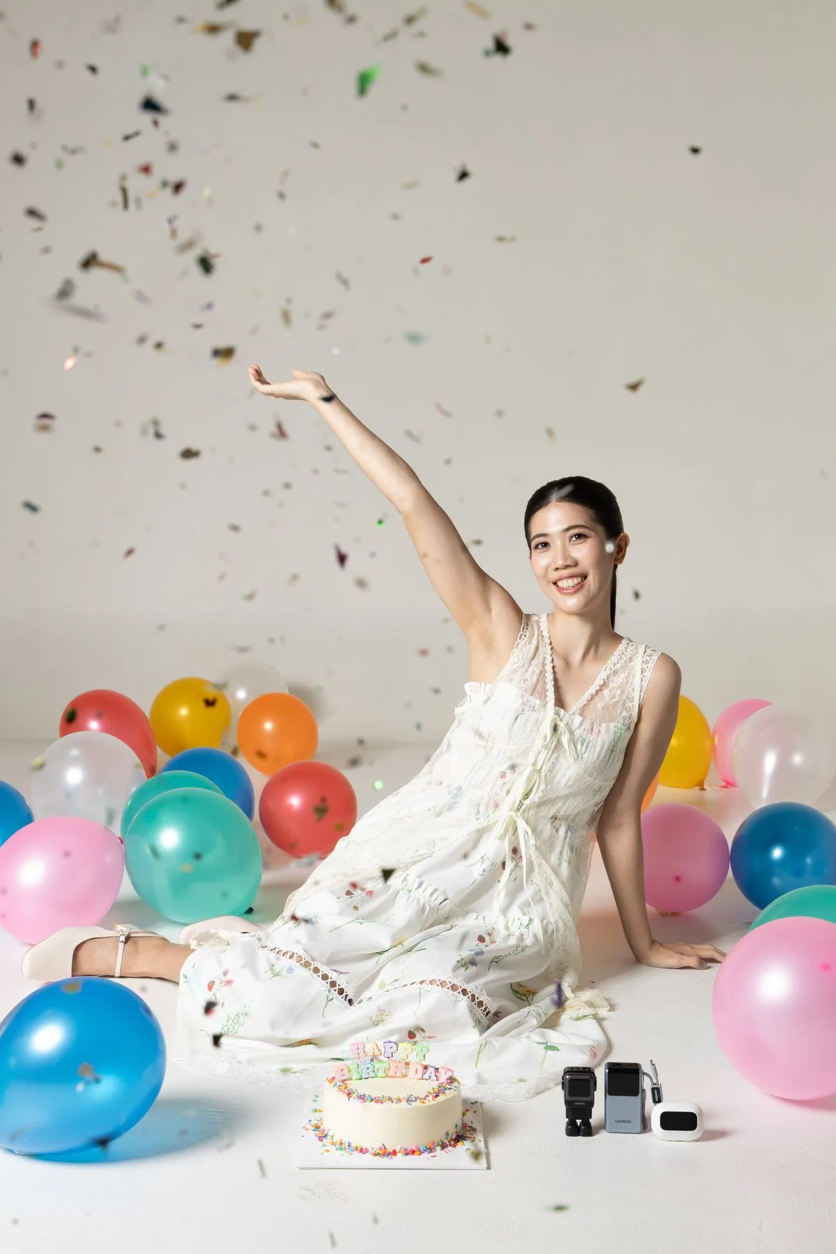 Tennis in a white dress, confetti and balloons