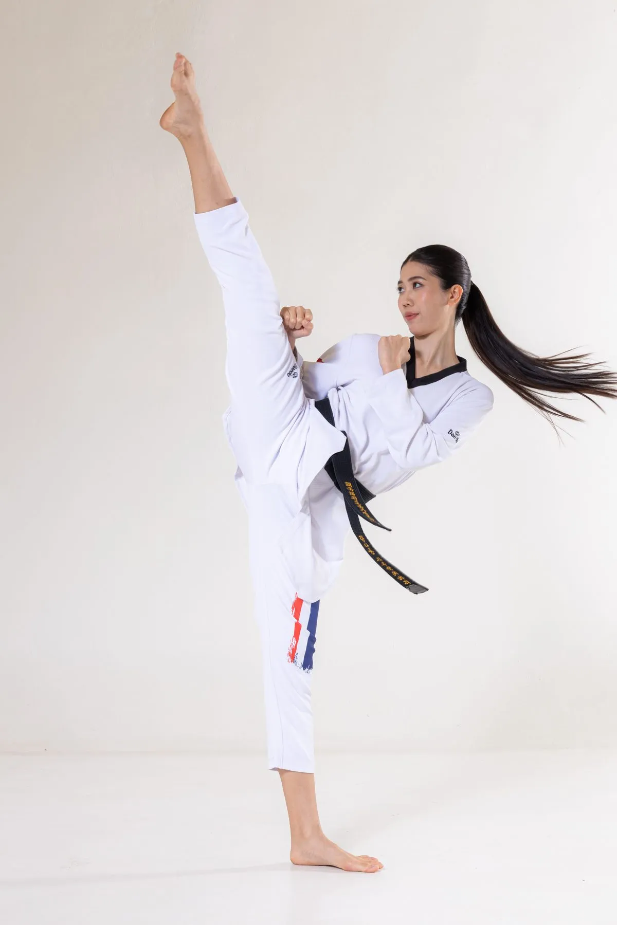 Tennis in her taekwondo uniform, high kick