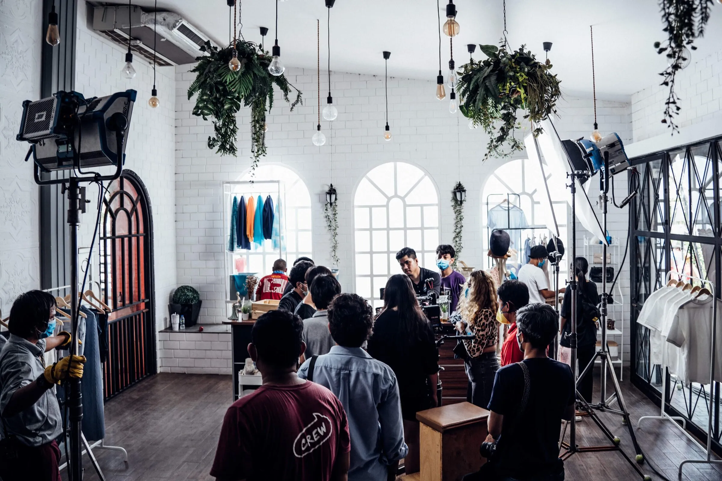 Visa commercial: boutique set with clothes rails, plants and hanging lamps