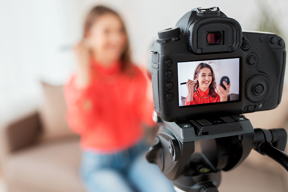 woman with bronzer and camera recording video PNGTRH2